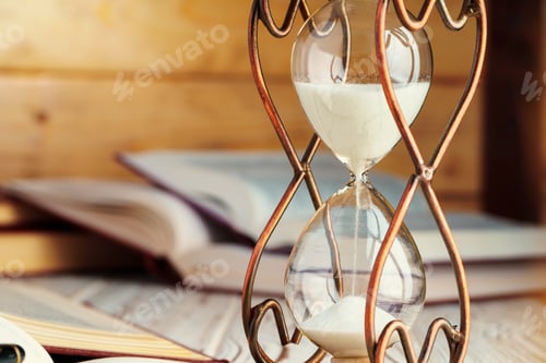 Preview: Hourglass with sand close up on wooden background