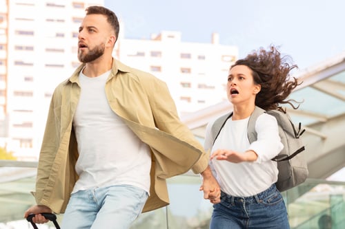 Preview: Man looking shocked holding woman's hand