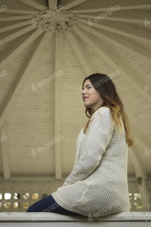 Preview: Young Casual Hipster Girl, Smilling, Sitting On Fence.