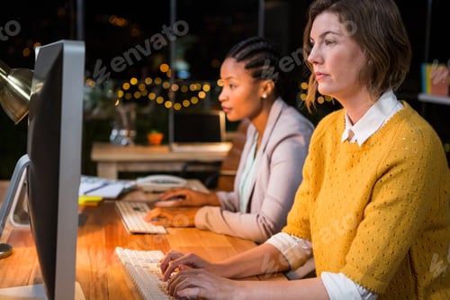 Preview: Businesswomen Working On Computer At Their Desk In The Office