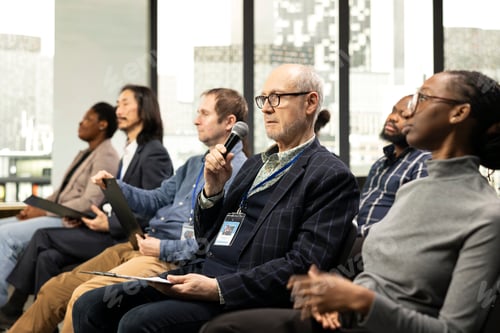 Preview: Senior press reporter with microphone asking questions from clipboard papers