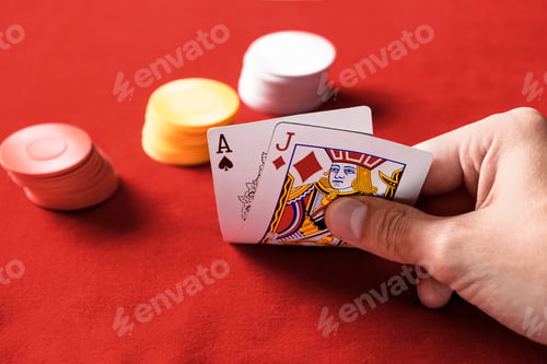 Preview: selective focus of man holding playing cards with chips on background