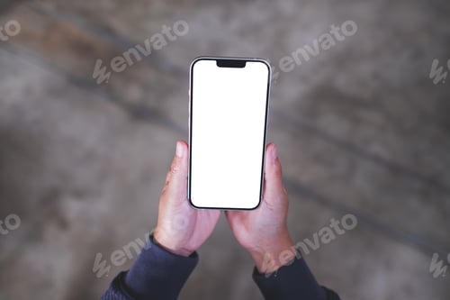 Preview: Top view mockup image of a woman holding mobile phone with blank white desktop screen