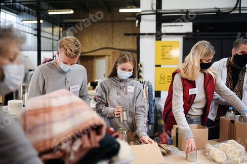 Preview: Group of volunteers in community charity donation center, food bank and coronavirus concept.