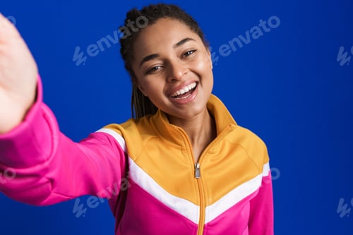 Preview: Black young woman laughing while taking selfie photo