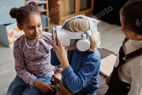 Preview: Two girls surrounding their classmate playing virtual game