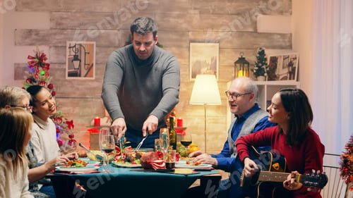 Preview: Girl singing a song on guitar while her father is slicing the chicken