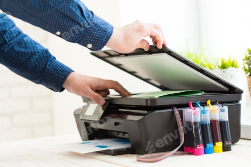 Preview: Man's hand making copies. Working with printer