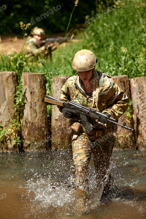 Preview: Portrait of fit military female holding weapon rifle in hands in river. Confident strong athlete