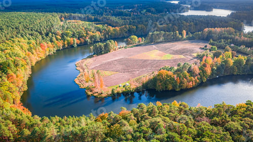Preview: Stunning turning river and autumn forest at sunset, aerial view