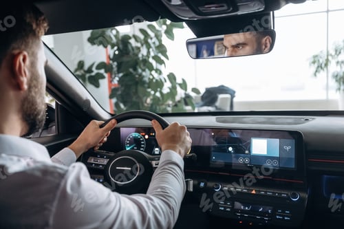 Preview: View from behind. Man is sitting in car, detailed view