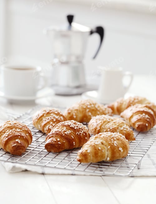 Delicious Croissants on Cooling Rack with Coffee