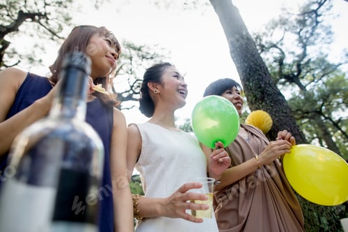 Preview: Group of friends at an outdoor party in a forest.