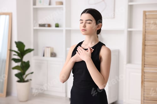 Preview: Beautiful girl meditating at home. Practicing yoga