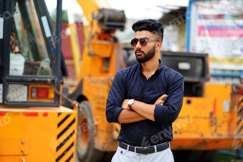 Preview: Indian businessman in a black shirt with a tractor on the background