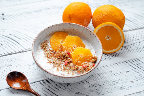Preview: Top view breakfast with oatmeal,orange and Granola