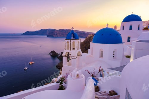 Preview: White churches an blue domes by the ocean of Oia Santorini Greece, traditional Greek village