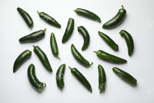 Preview: Green jalapeno peppers on white background, flat lay