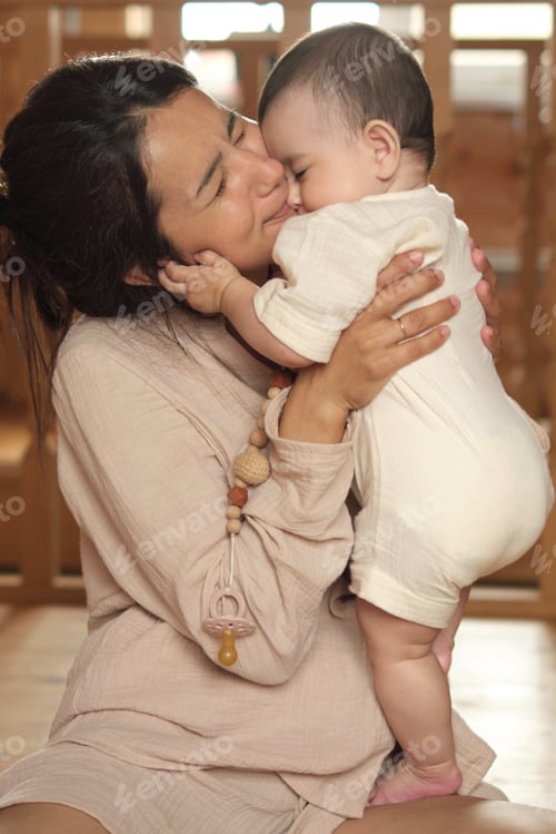 Preview: Nurturing Love: Inside a charming timber house, a mother finds her happy place, holding her baby