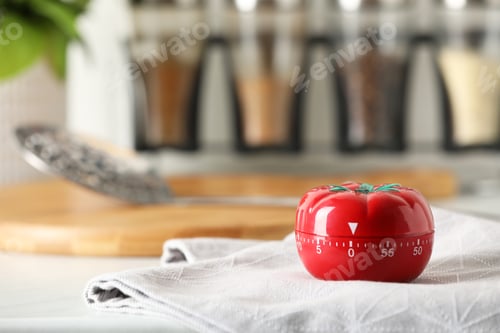 Preview: Kitchen timer in shape of tomato on white table. Space for text