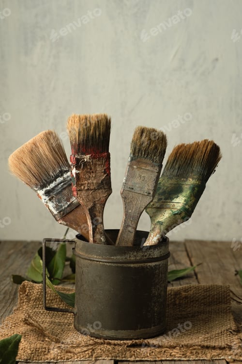 Preview: Old brushes inside an antique metal cup