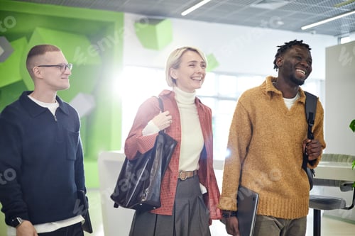 Preview: Multiethnic Young Adults Arriving at Modern Office and Smiling Together