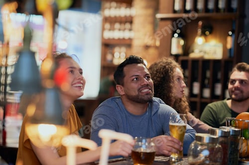 Preview: Group of friends watching match together in the pub