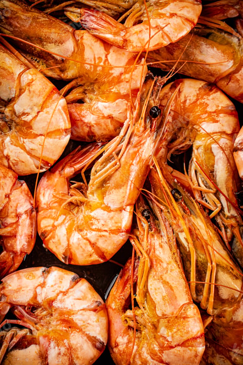 Preview: Red shrimp are boiled in water. Macro background.