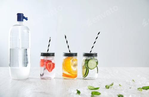 Preview: Soda syphon bottle near three rustic jars with icy fresh beverage
