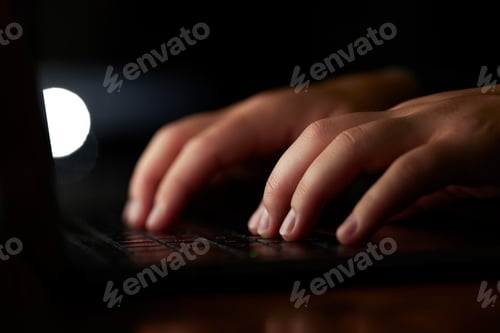 Preview: Laptop, typing and hands in dark room for information technology, programming and coding digital de