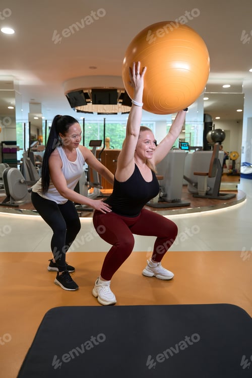 Preview: Blonde performs exercises under the supervision of a fitness trainer