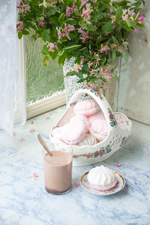 Preview: tender still life with full vase of vanilla marshmallows and glass of coffee with milk, next to vase