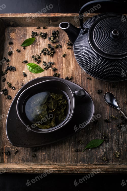 Preview: Teapot and cup with green tea