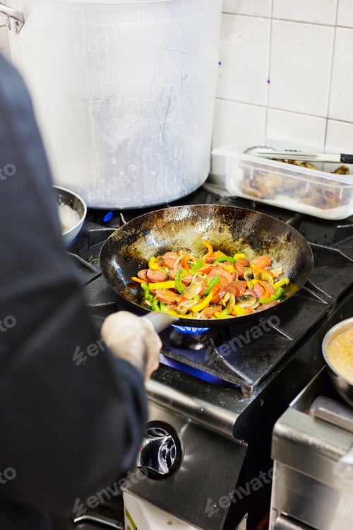 Preview: Cropped image of chef preparing meze in restaurant kitchen