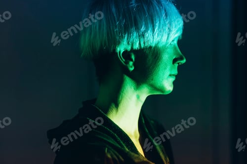 Preview: Woman daydreaming, green light reflected on face