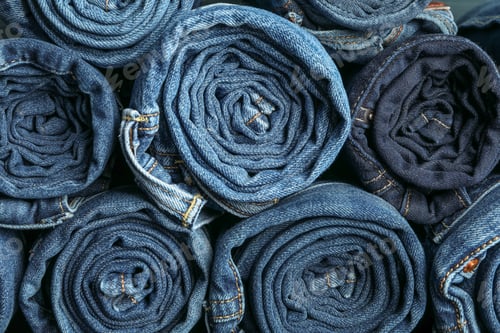 Preview: Background of a stack rolled jeans, space for text