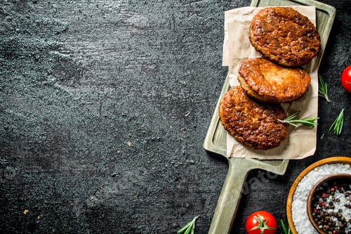 Preview: Cutlets on paper with spices in bowl.