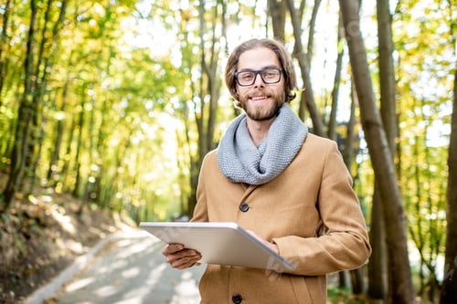 Preview: Creative man with tablet outdoors