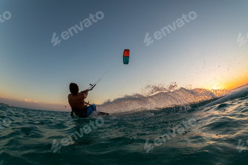 Preview: Person surfing and flying a parachute at the same time in Kitesurfing. Bonaire, Caribbean