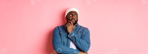 Preview: Doubtful african american man staring at upper left corner thoughtful, making decision and thinking