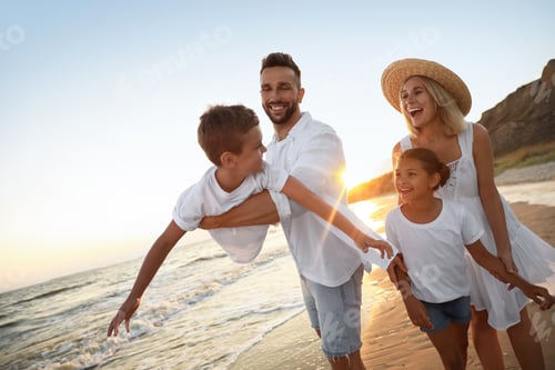 Preview: Happy family having fun on sandy beach near sea at sunset