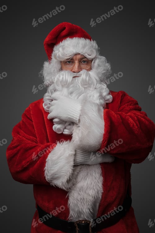 Preview: Christmas santa stroking his beard against gray background