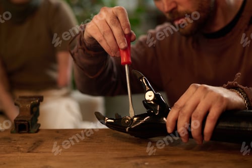 Preview: Male Repairman Fixing Prosthetic Arm