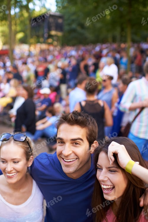 Preview: A group of smiling friends enjoying a music festival with crowd in the background