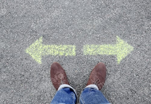 Preview: Man standing on road near arrows marking, closeup
