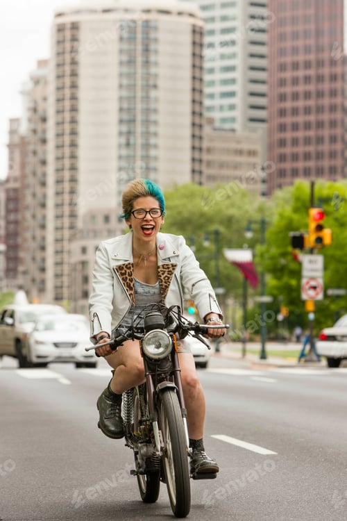 Preview: Portrait of young woman with colourful hair, riding motorcycle