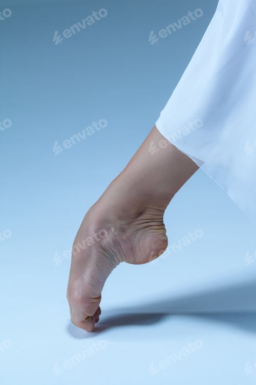 Preview: Close-up ballerina's leg on the blue floor
