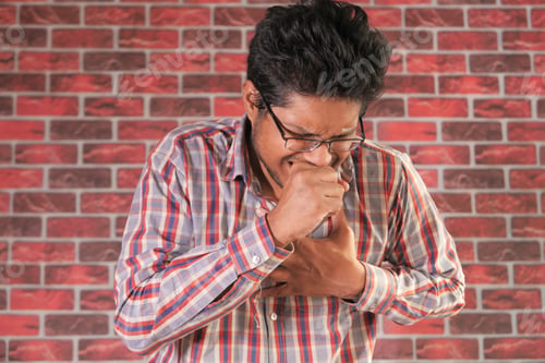 Preview: young asian man coughing and sneezes close up