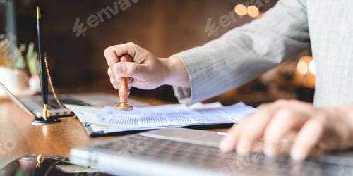 Preview: hand stamping with approved stamp on certificate document public paper at desk, notary or business