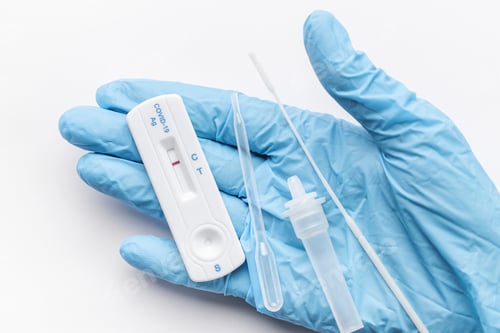 Preview: Doctor holding a negative result for COVID-19 with test kit for viral disease.